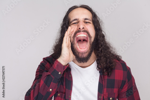 Portrait Of Roar Handsome Man With Beard And Black Long