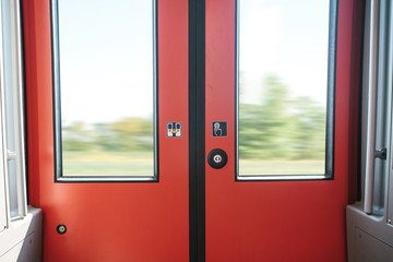 The exit door of the train with a button to automatically open the door on demand when the train stops.