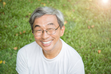 Portrait of healthy happy senior asian old man in the park outdoors with copy space. Spring healthcare lifestyle retirement concept