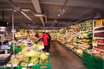 people shopping in modern supermarket