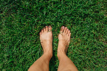 Bare Woman's Feet On The Fresh Green Grass