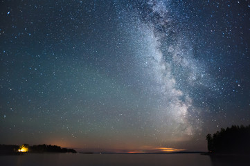 Wall Mural - milky way and stars above lake.