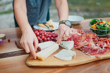 Cheese plate on a wooden table in the garden