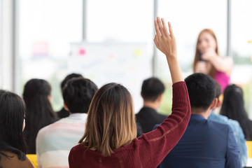 Wall Mural - student raising hand up in a classroom.