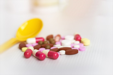 Medicine concept; Assorted pharmaceutical medicine pills, tablets and capsules.Heap of assorted various medicine tablets and pills different colors on white background.