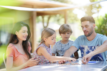 Wall Mural - Happy family enjoying playing game together