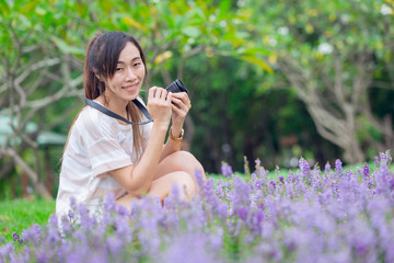 asian girl relax enjoy holiday with photography flower hobby in the park