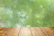 blur fresh wet moist green nature with wooden table foreground space for products decoration montage.