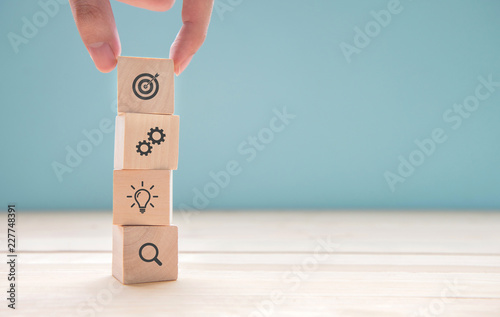Fotomural Businessman hand arranging wood block with icon business strategy and Action plan, copy space