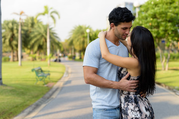 Young Hispanic couple relaxing in the park together