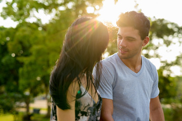 Young Hispanic couple relaxing in the park together