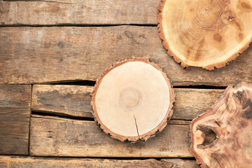 Wooden slices on rustic background. Round wooden pieces and copy space. Wooden discs for decoupage. Rustic still life.