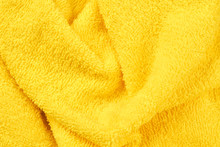 Yellow Fluffy Bath Towel Background. Vibrant Fuzzy Towel Close Up. Soft Textile Structure.