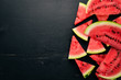 Fresh watermelon Fruits. Melon. On a black wooden background. Free space for text. Top view.