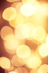 Wall Mural - Goldn  Lights Festive background. Abstract Christmas twinkled bright background with bokeh defocused yellow lights