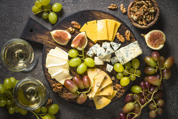 Cheese plate with grapes, figs and nuts.