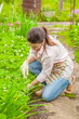© Ermolaev Alexandr - woman looks after a garden strawberry in a garden