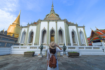 Woman tourist is enjoy traveling inside Wat Phra Keaw in Bangkok, Thailand.