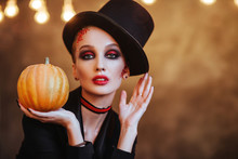 A Girl In Stylish Top Hat With Skull Make Up. Halloween Party.