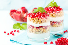 Pomegranate Parfait - Sweet Organic Layered Dessert With Granola Flakes, Yogurt And Red Ripe Fruit Seeds.