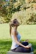 © Olesia - Girl meditates while practicing yoga outdoors in park