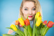 © Voyagerix - Pretty woman with red yellow tulips bunch