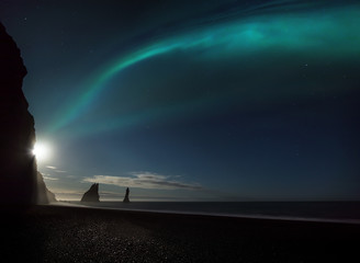 Wall Mural - aurora borealis over the iconic rock formation of reynisfjara black sand beach in iceland as the ful