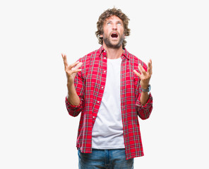 Canvas Print - Handsome hispanic model man over isolated background crazy and mad shouting and yelling with aggressive expression and arms raised. Frustration concept.