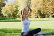 © Olesia - Girl meditates while practicing yoga outdoors in park