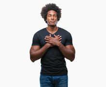 Afro American Man Over Isolated Background Smiling With Hands On Chest With Closed Eyes And Grateful Gesture On Face. Health Concept.