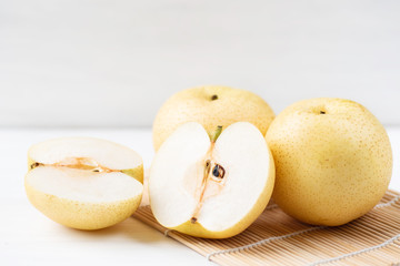 Fresh Asian pear fruit on bamboo sheet