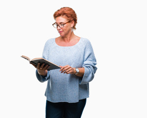 Canvas Print - Senior caucasian woman reading a book over isolated background with a confident expression on smart face thinking serious