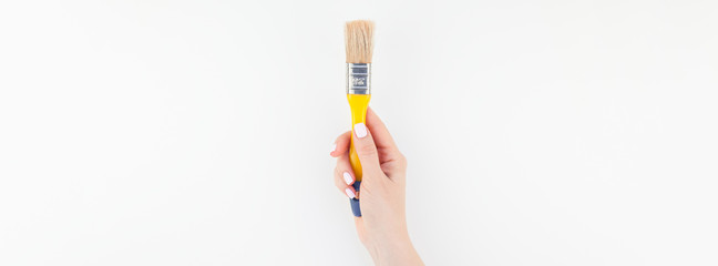 Woman hand holding new paint brush isolated