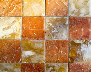 Colorful ceramic square street tiles background in yellow and orange colors