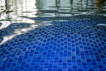 The Azur Mosaic Bottom Of An Aquapark Pool. A View To The Tiled Floor Through The Clean Water Of Indoor Pool. Ripples And Blinks On Water Surface Of Indoor Pool. Light And Darks Reflections In Pool