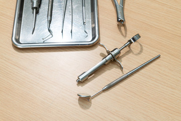 Dental tools and syringe at dentist's surgery