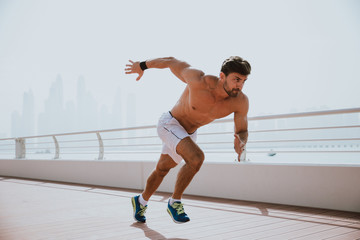 Beautiful man doing work out and different exercises outdoor