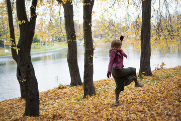 Wall Mural - Woman is dancing in the autumn in the park