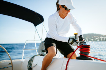 Wall Mural - Attractive strong woman sailing with her boat