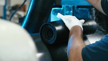 Industrial Production Of Rubber Sheet 4K. Long Shot Of Industrial Process Rolling The Rubber Sheet In Focus From Machine Cylinders.