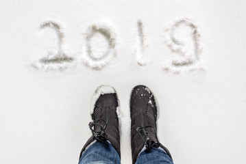 Wall Mural - Selfie of boots and 2019 written in the snow, winter concept