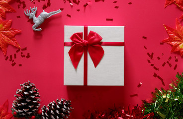 top view of gift box on red background with Christmas decoration