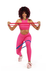 Sticker - Muscular young fit sports woman athlete in pink sportswear with bands or expander in gym. Copy space for fitness nutrition ads.