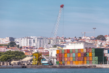 Cargo containers in the port. Marine crane lifts the cargo container. Import export transportation, logistics business, customs.