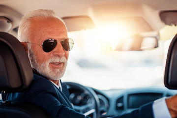 Wall Mural - Handsome senior man driving a car