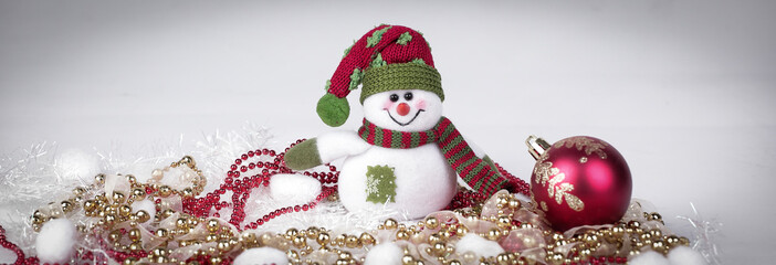 cute toy snowman and various Christmas decorations on a white b