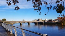 Limerick City Skyline Ireland. Beautiful Limerick Urban Cityscape Over The River Shannon On A Sunny Day With Blue Skies.