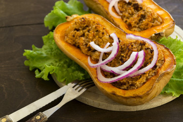 Stuffed baked pumpkin. close-up on a wooden table.