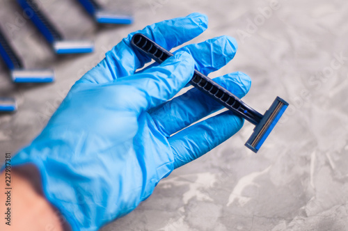 Mens Hand In Rubber Glove Holds One Disposable Blue And Black
