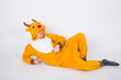 © satura_ - Joke, christmas, people concept - man in deer costume lying on the floor on white background